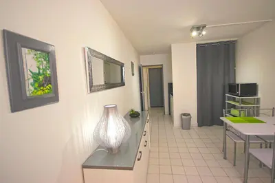 a kitchen and dining room with a table and chairs at Magnan et ses plages de la Promenade des Anglais in Nice
