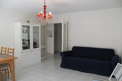 a living room with a blue couch and a table at Long stay in Old town of Nice, Castle Hill in Nice