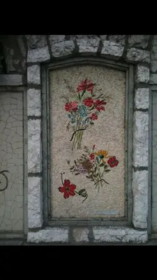 a painting of flowers on a stone wall at Long stay in Old town of Nice, Castle Hill in Nice