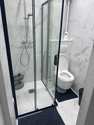a bathroom with a glass shower with a toilet at Beautiful and super central in Nice