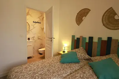 a bedroom with a bed with green pillows on it at Cap de Nice in Nice