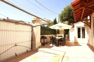a patio with a table and an umbrella at Cap de Nice in Nice