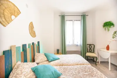 a bedroom with a bed and a desk and a window at Cap de Nice in Nice