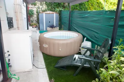 a hot tub and a chair in a backyard at Cap de Nice in Nice