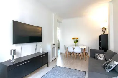 a living room with a large flat screen tv on a wall at Résidence Estienne d'Orves in Nice