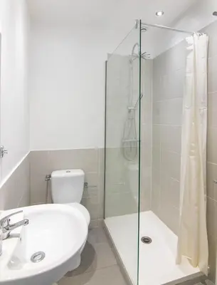 a bathroom with a shower and a toilet and a sink at Résidence Estienne d'Orves in Nice