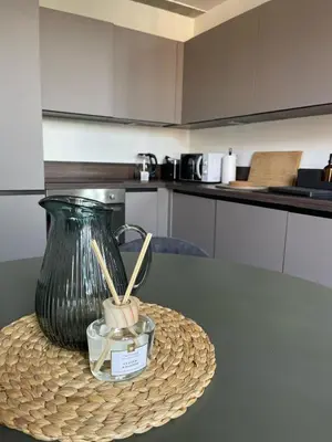 a table with a green vase on top of it at Duplex Place Garibaldi - Close to port, Old Nice in Nice