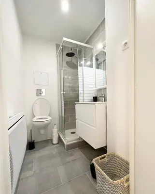 a bathroom with a toilet and a glass shower at Super studio bord de mer, promenade des anglais in Nice
