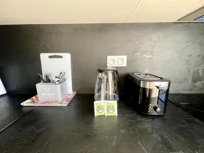 a counter top with a coffee maker and a blender at Studio proche mer, avec terrasse et parking in Nice