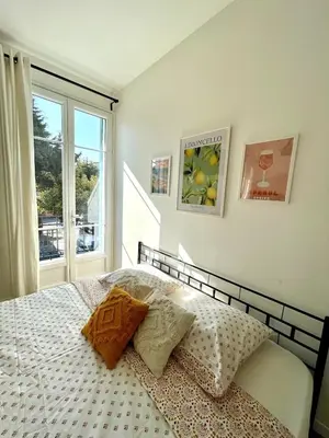 a bedroom with a bed with two pillows and a window at Studio proche mer, avec terrasse et parking in Nice