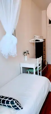 a bedroom with a white bed and a desk at Guest bedroom in private home, quiet, elegant, 10 mins to beach, 1 triple and 1 double bedrooms in Nice