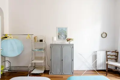 a living room with a gray cabinet and chairs at Guest bedroom in private home, quiet, elegant, 10 mins to beach, 1 triple and 1 double bedrooms in Nice