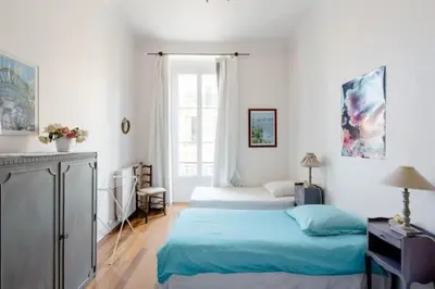 a bedroom with two beds and a desk and a window at Guest bedroom in private home, quiet, elegant, 10 mins to beach, 1 triple and 1 double bedrooms in Nice