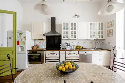 a kitchen with a table with a bowl of fruit on it at Guest bedroom in private home, quiet, elegant, 10 mins to beach, 1 triple and 1 double bedrooms in Nice
