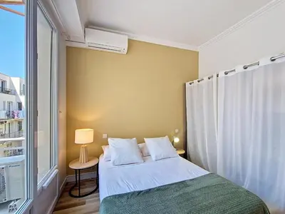 a small bedroom with a bed and a window at Nestor&Jeeves - CASA SOLANA - Terrace - Central in Nice