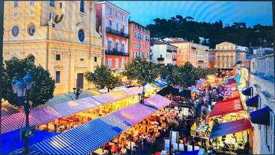 a crowd of people walking around a market in a city at A room in Nice Beach in Nice