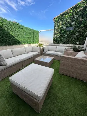 a patio with a couch and a table and grass at Spacious, quiet apartment in Nice