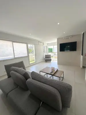 a living room with a couch and a table at Spacious, quiet apartment in Nice