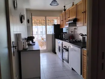 a kitchen with a refrigerator and a stove top oven at Près de la promenade in Nice