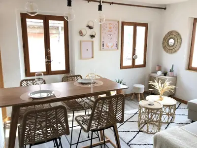 a dining room with a table and chairs at Cosy Studio Sea view in Villefranche-sur-Mer