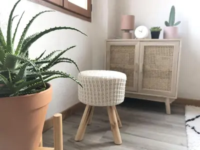a rattan chair in a living room with a plant at Cosy Studio Sea view in Villefranche-sur-Mer
