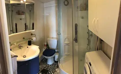 a bathroom with a shower and a sink and a toilet at Cosy Studio Sea view in Villefranche-sur-Mer