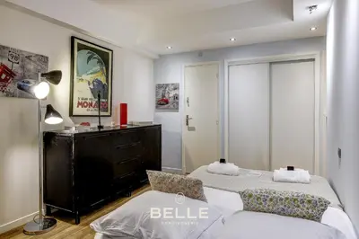 a bedroom with two beds and a dresser in it at Le Rivoli Niçois - 180m2 - 3 Chambres in Nice