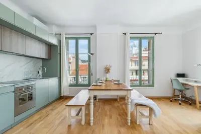 a kitchen with a table and two chairs in it at Happyfew Cathedrale in Nice