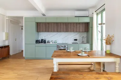 a kitchen with a wooden table in a room at Happyfew Cathedrale in Nice