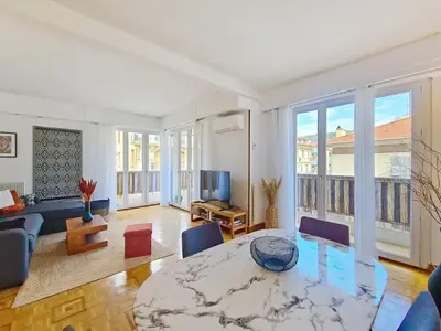 a living room with a table and a tv at Nestor&Jeeves - TROPI AZUR - Terrace - Place du Pin in Nice