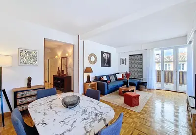a living room with a table and a couch at Nestor&Jeeves - TROPI AZUR - Terrace - Place du Pin in Nice