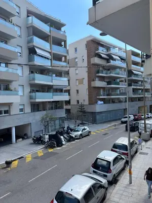 a parking lot with cars parked next to a building at Studio Proche Tram accès Centre Ville Plage in Nice