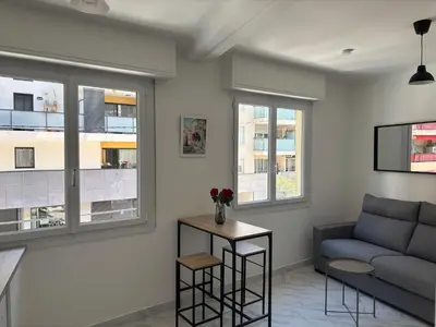 a living room with a couch and a table at Studio Proche Tram accès Centre Ville Plage in Nice