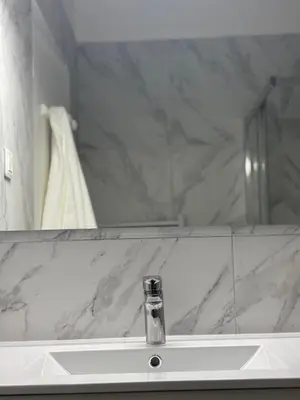 a bathroom with a sink and a mirror at Studio Proche Tram accès Centre Ville Plage in Nice