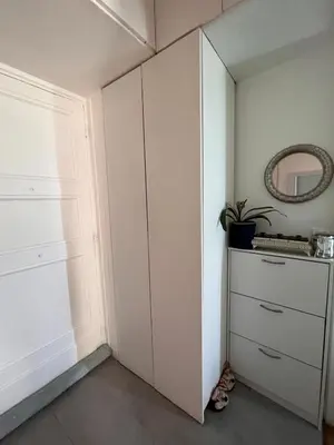 a white closet with a dresser and a mirror at Lovely apartment nice in Nice