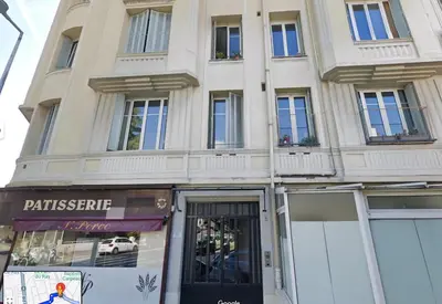 a large white building with windows and a store at Lovely apartment nice in Nice