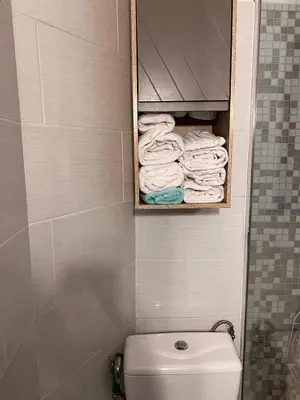 a bathroom with a toilet and a bunch of towels at Lovely apartment nice in Nice