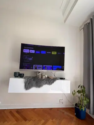 a television on a white shelf in a room at Lovely apartment nice in Nice