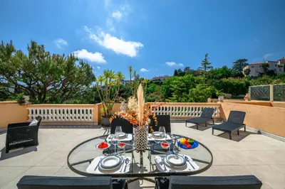 a patio with a table and chairs on a patio at Nice Fabron, terrasse & piscine dans résidence in Nice