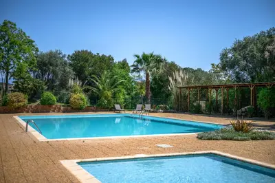 a swimming pool in the middle of a yard at Nice Fabron, terrasse & piscine dans résidence in Nice