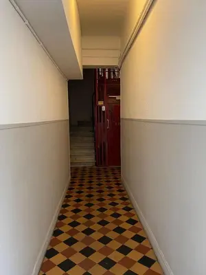 a hallway with a checkered floor and a red door at Charming Riviera Top-Floor Apartment near the Beach in Nice