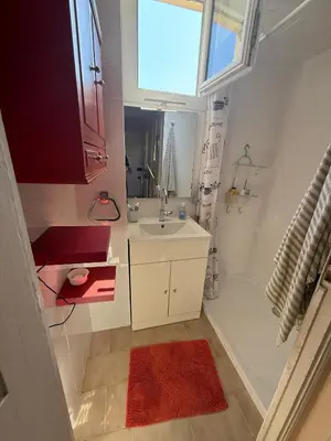 a small bathroom with a sink and a window at Charming Riviera Top-Floor Apartment near the Beach in Nice