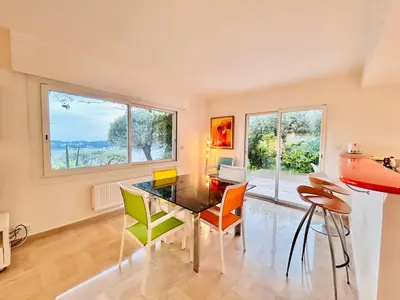 a dining room with a glass table and chairs at Golden Mornings, Sea, Garden, Breakfast & Free Parking in Villefranche-sur-Mer