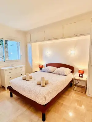 a bedroom with a large bed with two towels on it at Golden Mornings, Sea, Garden, Breakfast & Free Parking in Villefranche-sur-Mer