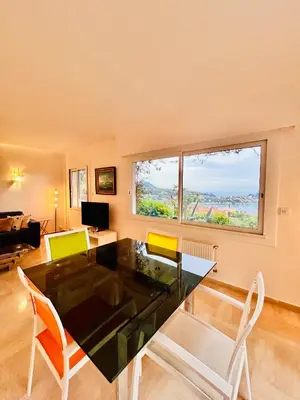 a living room with a table and chairs and a window at Golden Mornings, Sea, Garden, Breakfast & Free Parking in Villefranche-sur-Mer