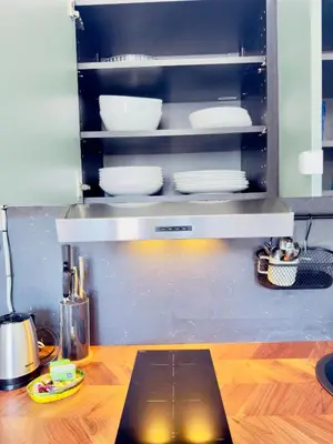 a kitchen with a shelf with plates and dishes at New Alba 3 Pers WiFi AC in Nice
