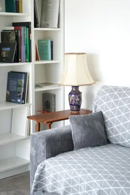 a lamp sitting on a table next to a couch at Sea view apartment close to beaches in Cagnes-sur-Mer