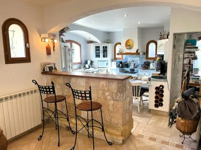 a kitchen with two bar stools and a counter top at Maison Familiale 3 chambres Cœur de la Nature in Drap