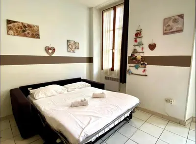 a bedroom with a bed with two towels on it at 2 pièces avec clim proche place Masséna in Nice