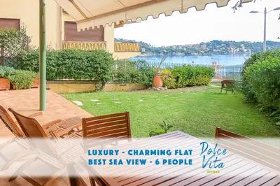 a patio with chairs and a view of the water at Le Marie Jeanne 6 Pers Giardino Vista Mare in Villefranche-sur-Mer